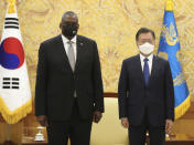 South Korean President Moon Jae-in, right, stands for the media with U.S. Defense Secretary Lloyd Austin before their meeting at the presidential Blue House in Seoul, South Korea, Thursday, Dec. 2, 2021. Austin said Thursday that China's pursuit of hypersonic weapons "increases tensions in the region" and vowed the U.S. would maintain its capability to deter potential threats posed by China. (Ahn Jung-hwan/Yonhap via AP)