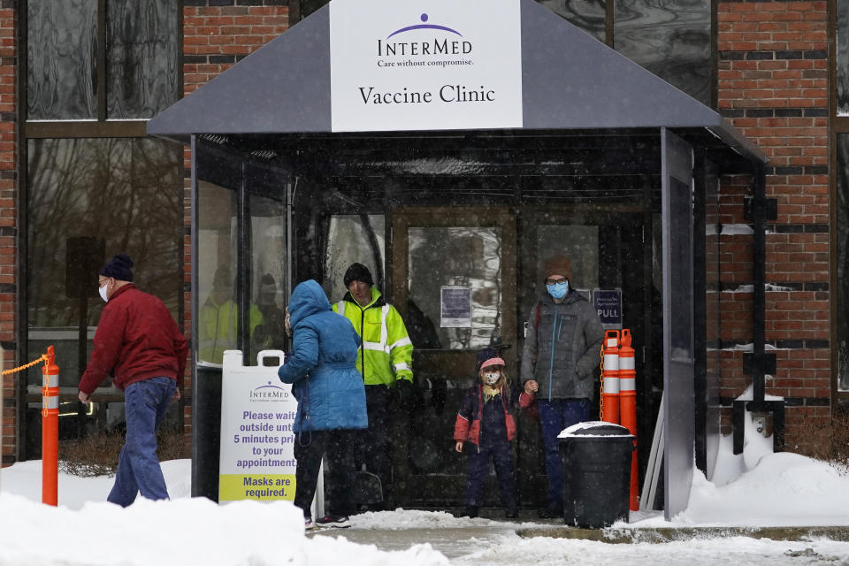 People leave a vaccine clinic during a winter snow storm, Tuesday, Feb. 2, 2021, in South Portland, Maine. (AP Photo/Robert F. Bukaty)