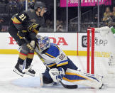 St. Louis Blues goaltender Jordan Binnington (50) defends against Vegas Golden Knights center Brett Howden (21) during the second period of an NHL hockey game Wednesday, Oct. 20, 2021, in Las Vegas. (AP Photo/David Becker)