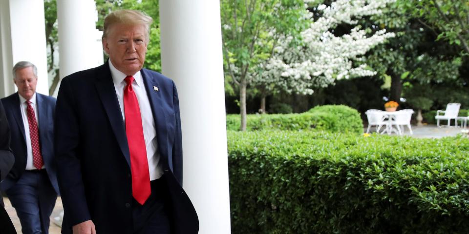 FILE PHOTO: U.S. President Donald Trump walks down the West Wing colonnade to the Oval Office before an interview about China, the novel coronavirus (COVID-19) pandemic and other subjects at the White House in Washington, U.S., April 29, 2020. REUTERS/Carlos Barria