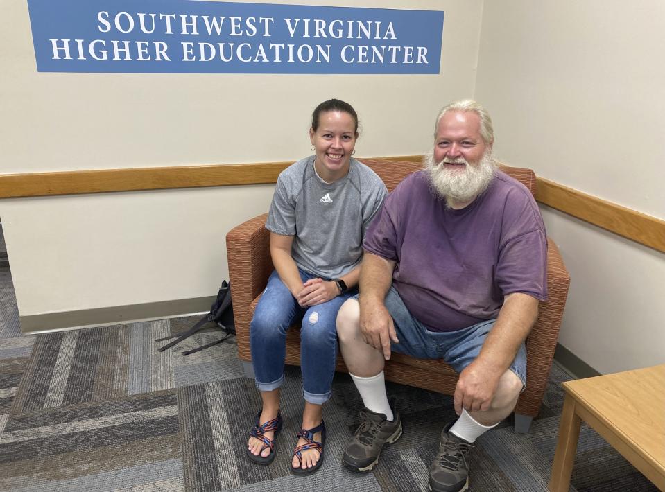 Ernest Ray, right, sits with his niece, Kendra Potter at the Virginia Higher Education Center in Abington Va., Tuesday Aug. 17, 2021. Ray has been fighting the state of Virginia in court as it tries to recoup unemployment benefits he received after being laid off from his job of more than two decades. (AP Photo/Sarah Rankin)