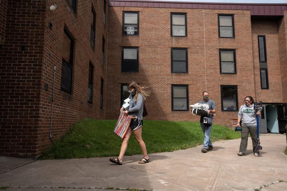 Lake Superior State University junior Rebecca Weipert carries her items with the help of her father William Weipert and mother Heidi Weipert at Osborn Hall during a move-in day for students at Lake Superior State University in Sault Ste. Marie.