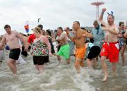 NEW YORK, NY - JANUARY 1: People run into the chilly water as they take part in the Coney Island Polar Bear Club's New Year's Day swim on January 1, 2013 in the Coney Island neighborhood of the Brooklyn borough of New York City. The annual event attracts hundreds who brave the icy Atlantic waters and temperatures in the upper 30's as a way to celebrate the first day of the new year. (Photo by Monika Graff/Getty Images)