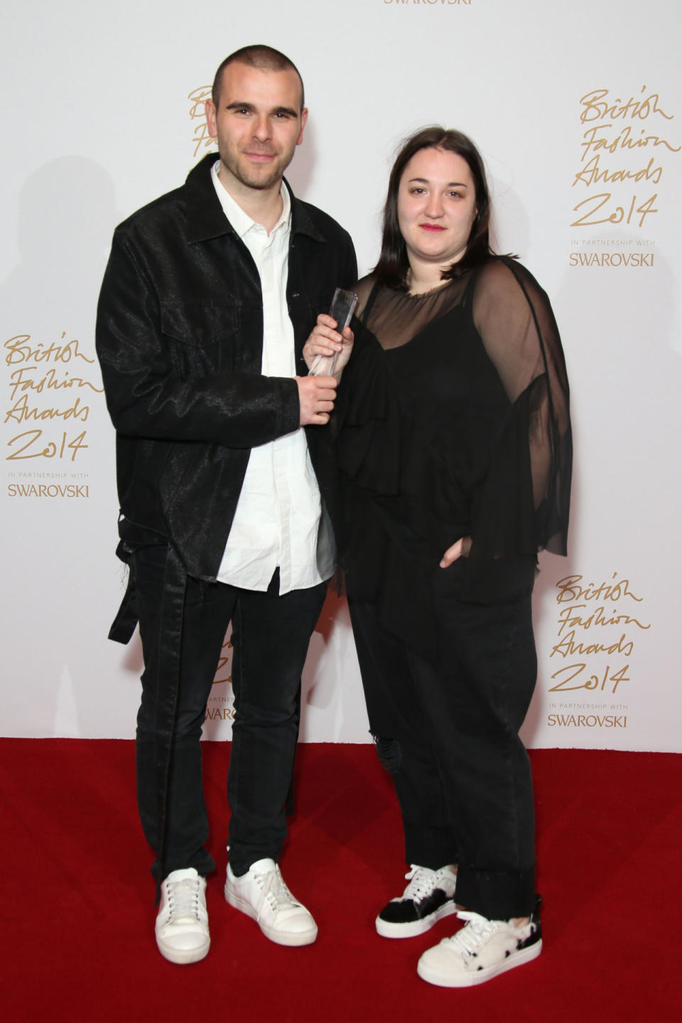 Paulo Almeida and Marta Marques of Marques Almeida pose in the winners room with their Emerging Womenswear Designer Award.