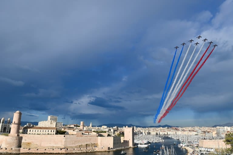 The French Air Force display team sprays the colours of the French flag above Marseille's Old Port as the Olympic flame arrives (Sylvain THOMAS)