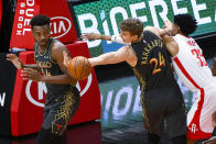 Chicago Bulls center Wendell Carter Jr., left, and forward Lauri Markkanen, center, chase a rebound against Houston Rockets center Christian Wood, right, during the first half of an NBA basketball game Monday, Jan. 18, 2021, in Chicago. (AP Photo/Matt Marton)