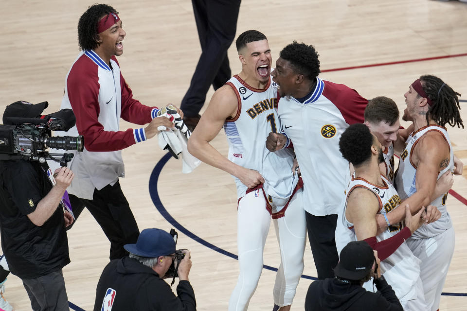 Denver Nuggets players celebrate after winning the NBA Championship with a victory over the Miami Heat in Game 5 of basketball's NBA Finals, Monday, June 12, 2023, in Denver. (AP Photo/David Zalubowski)