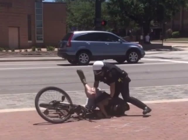 <p>Footage showing College Station Police Department officers tackle a cyclist, who was tasered </p> (Reddit/u/Thep_Erson)