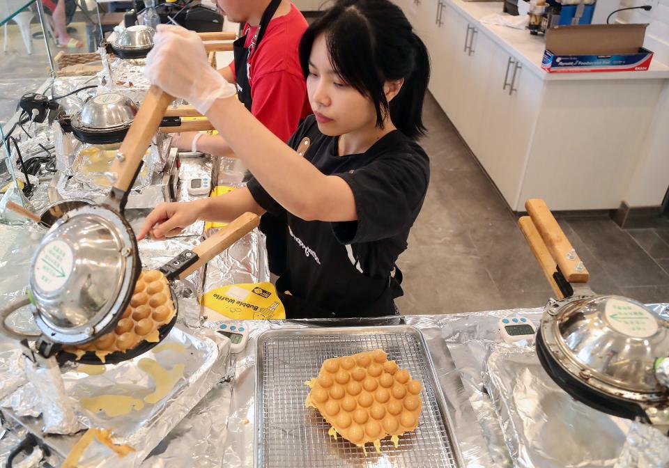 Happy Lemon manager Nora Nguyen prepares bubble waffles for customers at Happy Lemon's new location in Silverdale on Monday, Aug. 7, 2023.