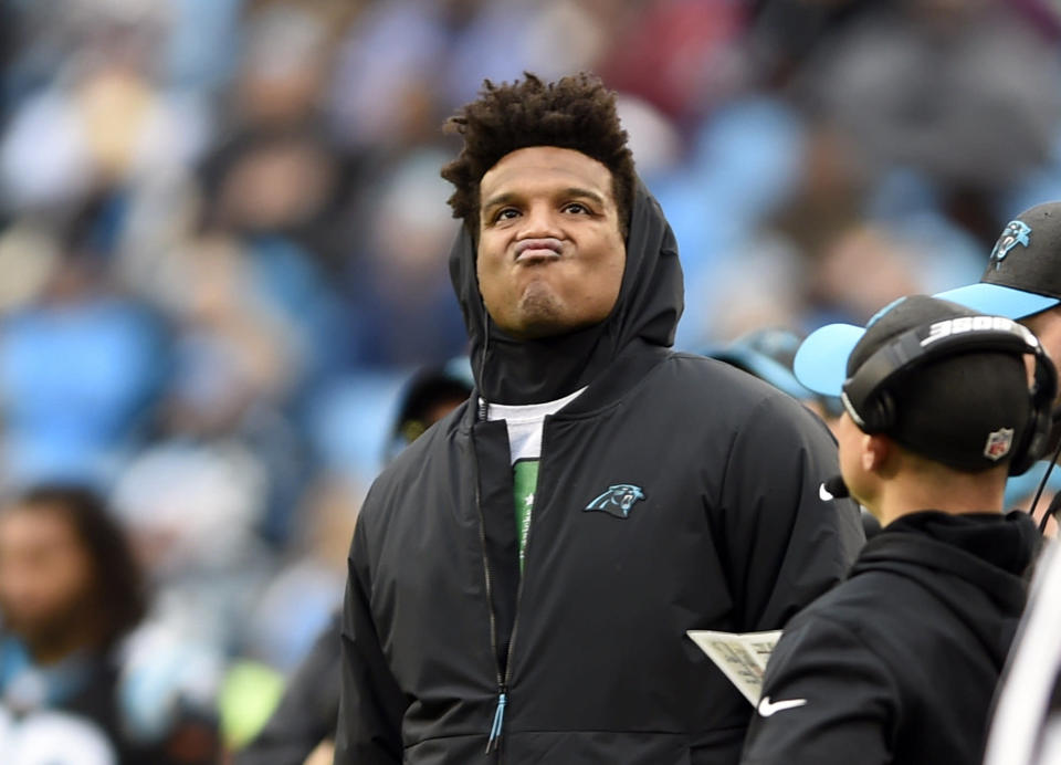 Carolina Panthers' Cam Newton watches the action from thew sidelines during the second half of an NFL football game against the Atlanta Falcons in Charlotte, N.C., Sunday, Dec. 23, 2018. (AP Photo/Mike McCarn)