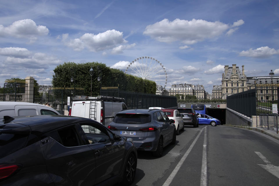 Cars are stuck in the traffic in Paris Thursday, July 20, 2023. Paris 2024 Olympics organisers are counting on spectators to rely overwhelmingly on the Paris region's dense network of Metro lines, suburban trains, buses and other transport to help the Games reach its target of halving its carbon footprint compared to previous editions. (AP Photo/Christophe Ena)