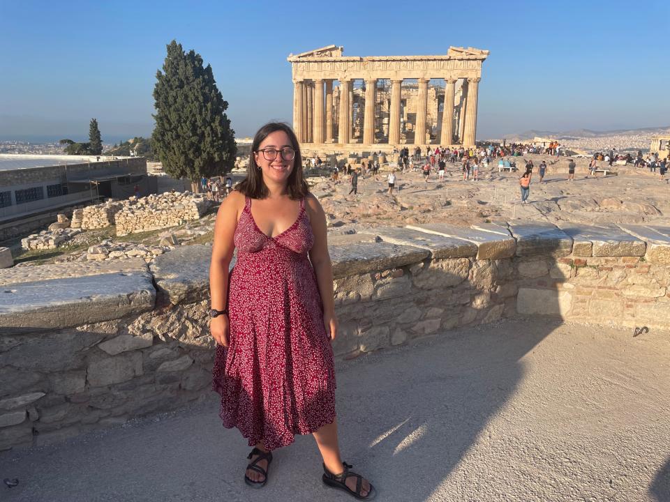 hannah posing in front of the acropolis in athens