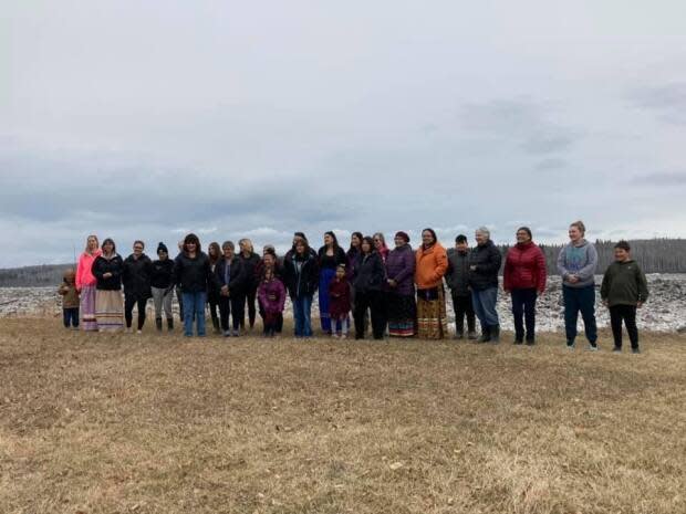 Fort Simpson residents gathered by the river to pray as water levels threatened to inundate the island where the majority of the community's residents live.  (Submitted by Pat Waugh - image credit)