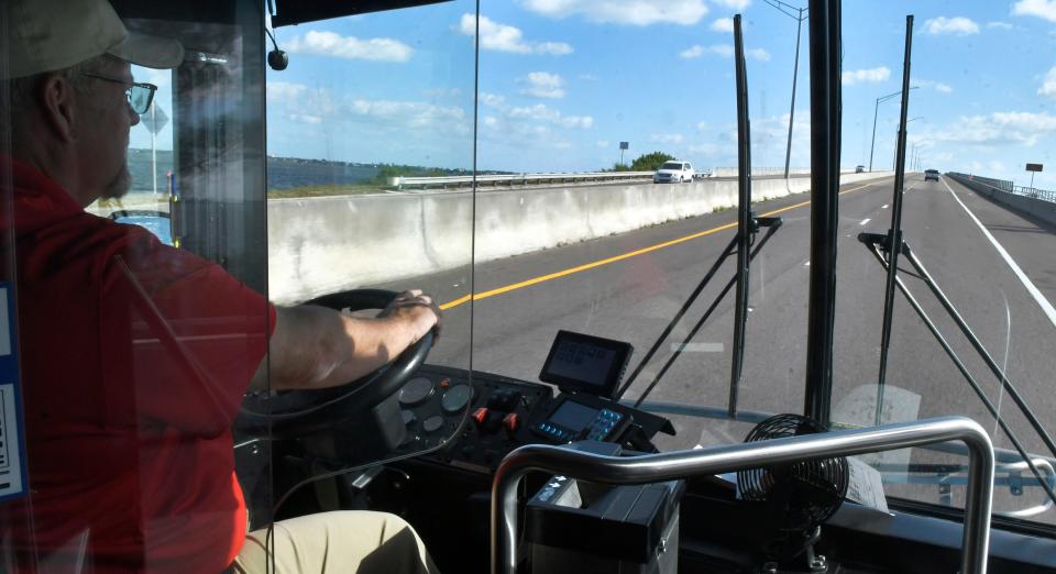 A Space Coast Area Transit bus heading east over the Eau Gallie Causeway.