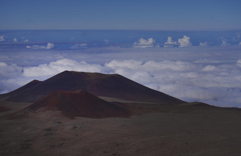 The summit of Mauna Kea on the Big Island of Hawaii, on Saturday, July 15, 2023. Mauna Kea was born after a series of volcanic eruptions from the ocean floor created new land. Over a million years, it grew into the tallest mountain on earth when measured from its base in the Pacific Ocean to its summit soaring 13,796 feet (4,205 meters) above sea level. (AP Photo/Jessie Wardarski)