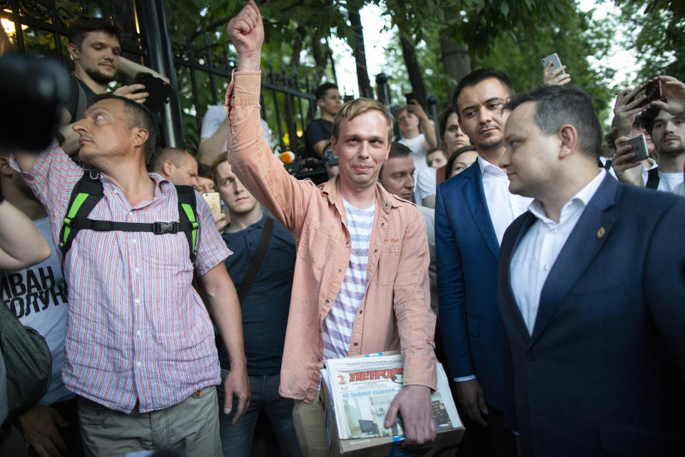 Prominent Russian investigative journalist Ivan Golunov, centre, gestures as he leaves a Investigative Committee building in Moscow, Russia, Tuesday, June 11, 2019. In a surprising turnaround, Russia's police chief on Tuesday dropped all charges against a prominent investigative reporter whose detention sparked public outrage and promised to go after the police officers who tried to frame the journalist as a drug-dealer. (AP Photo/Alexander Zemlianichenko)