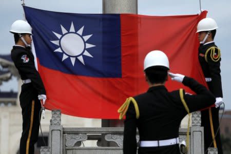 FILE PHTO: Military honour guards attend a flag-raising ceremony at Chiang Kai-shek Memorial Hall, in Taipei, Taiwan March 16, 2018. REUTERS/Tyrone Siu