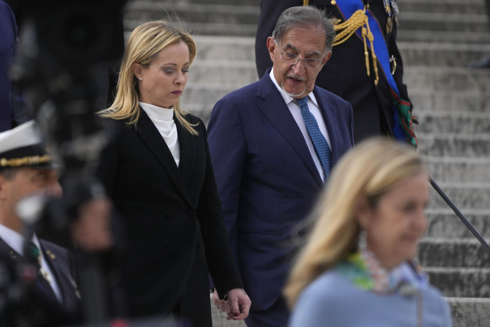 Italian Senate President Ignazio La Russa, right, and Italian Premier Giorgia Meloni attend a ceremony to mark Italy's Liberation day at the unknown soldier monument during, in Rome, Tuesday, April 25, 2023. The anniversary marks the day in 1945 when the Italian resistance movement proclaimed an insurgency as the Allies were pushing German forces out of the peninsula. (AP Photo/Gregorio Borgia)