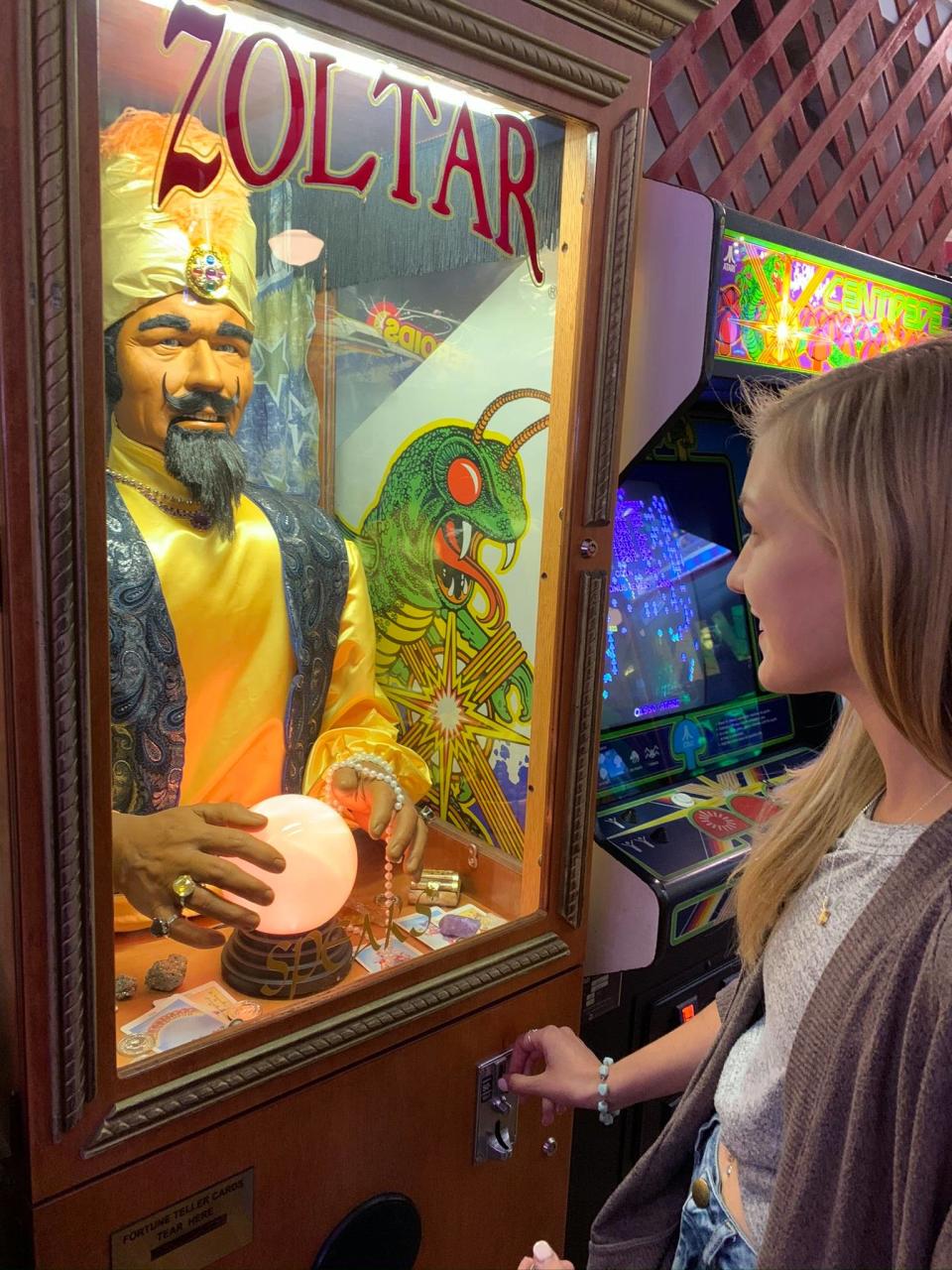 Gabby Petito looks at a mechanical fortune teller in an arcade. (Find Gabby Facebook page)