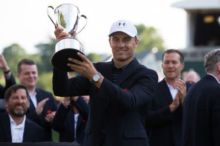 Jun 25, 2017; Cromwell, CT, USA; Jordan Spieth holds the Championship trophy after a victory in the first playoff hole during the final round of the Travelers Championship golf tournament at TPC River Highlands. Mandatory Credit: Bill Streicher-USA TODAY Sports