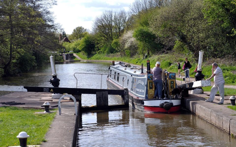 Narrowboat leaving Warwick Bottom Lock, Grand Union Canal, Warwickshire, England