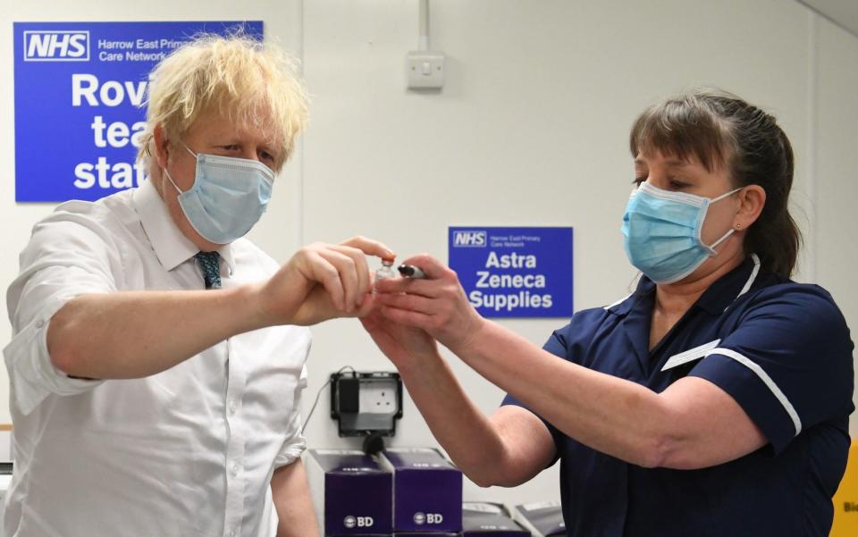 Boris Johnson is shown the Oxford/AstraZeneca COVID-19 vaccine with nurse Tracey Wilkinson at Barnet FC's ground at The Hive - Getty