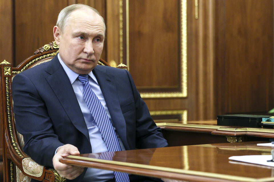 Russian President Vladimir Putin listens to chairman of the Supreme Court Vyacheslav Lebedev at the Kremlin in Moscow, Russia, Tuesday, Feb. 6, 2024. (Alexander Kazakov, Sputnik, Kremlin Pool Photo via AP)