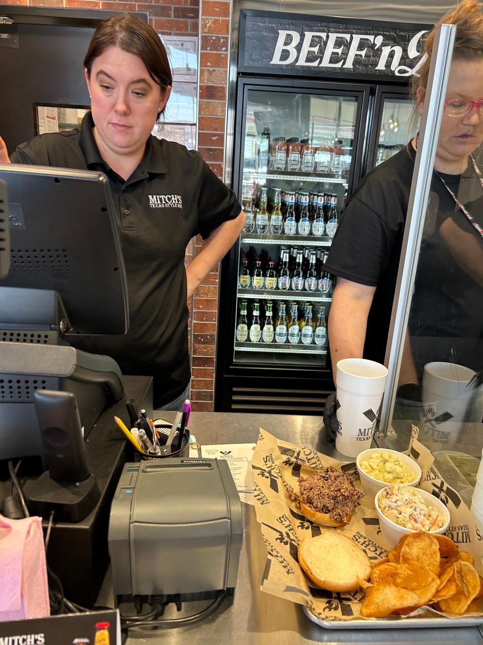 Sheron Vonmerta, left, rings up a BBQ beef sandwich with delicious sides at Mitch's BBQ on 34th & Georgia.