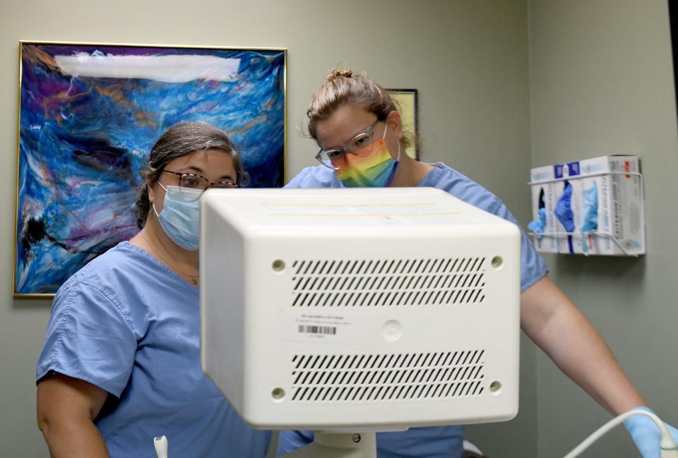 Nurse Kelley Lott and OB-GYN resident Deanna Lines conduct an ultrasound to check the gestation of pregnancy as part of a patient consultation Friday at Northeast Ohio Women's Center in Cuyahoga Falls.