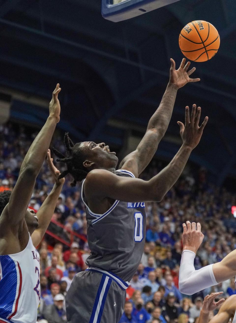 Seton Hall Pirates guard Kadary Richmond (0) shoots as Kansas Jayhawks forward K.J. Adams Jr. (24) defends during the first half at Allen Fieldhouse.