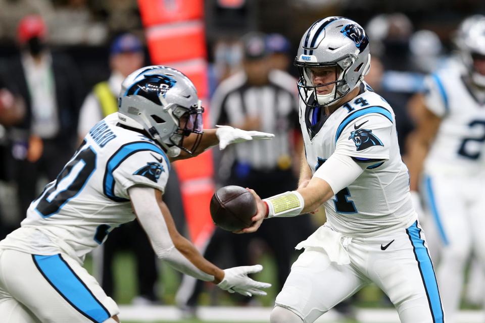 Jan 2, 2022; New Orleans, Louisiana, USA; Carolina Panthers quarterback Sam Darnold (14) hands off to running back Chuba Hubbard (30) in the first quarter against the New Orleans Saints at the Caesars Superdome. Mandatory Credit: Chuck Cook-USA TODAY Sports