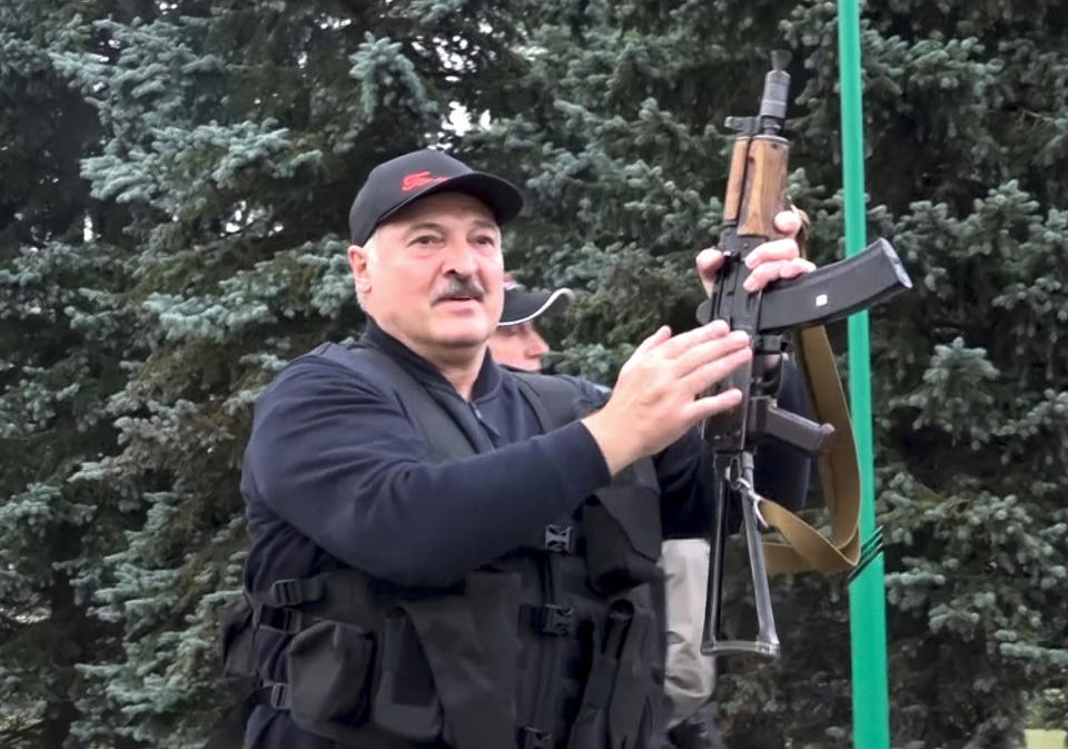 FILE - This photo made from video provided by the State TV and Radio Company of Belarus, shows Belarus President Alexander Lukashenko armed with a Kalashnikov-type rifle near the Palace of Independence in Minsk, Belarus on Sunday, Aug. 23, 2020. For most of his 27 years as the authoritarian president of Belarus, Alexander Lukashenko has disdained democratic norms, making his country a pariah in the West and bringing him the sobriquet of “Europe’s last dictator." Now, his belligerence is directly affecting Europe. (State TV and Radio Company of Belarus via AP, File)