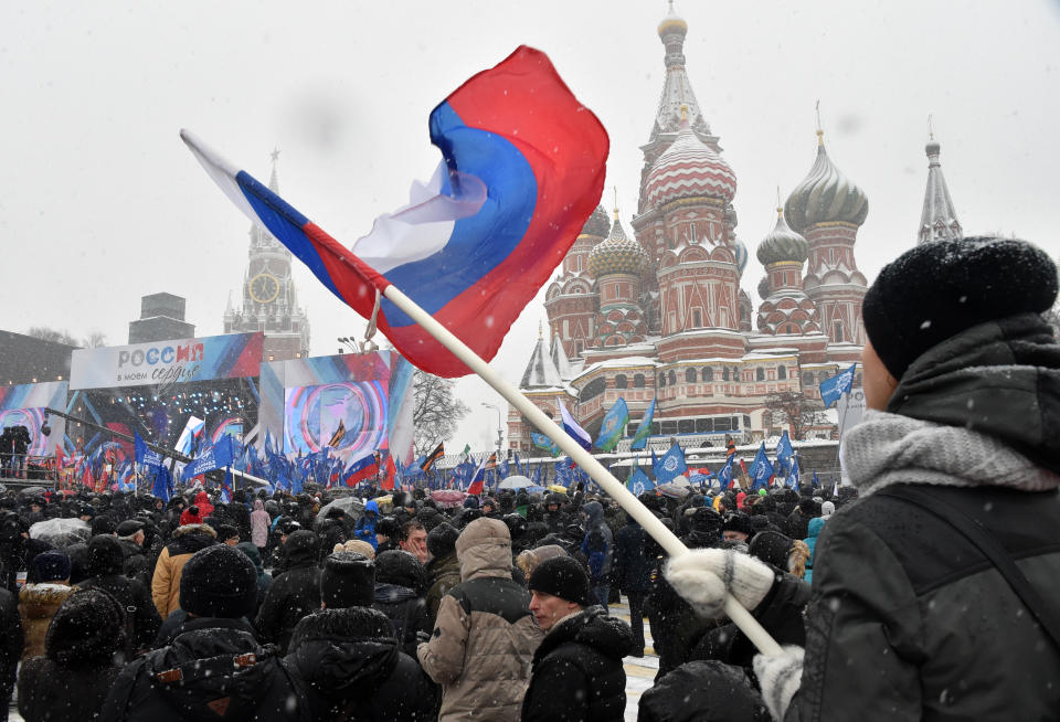 A man holds a national flag during the 'Russia is in my heart!' rally in support of Russian athletes on February 3, 2018 in central Moscow. The IOC's disciplinary commission banned 43 Russian athletes for life and disqualified Russia from competing at the Pyeongchang Games over the doping conspiracy. Following an appeal by 42 athletes, CAS cleared 28 citing insufficient evidence against them and also lifted the life ban on 11 others, but barred them from taking part in the 2018 Olympics. / AFP PHOTO / Vasily MAXIMOV        (Photo credit should read VASILY MAXIMOV/AFP/Getty Images)