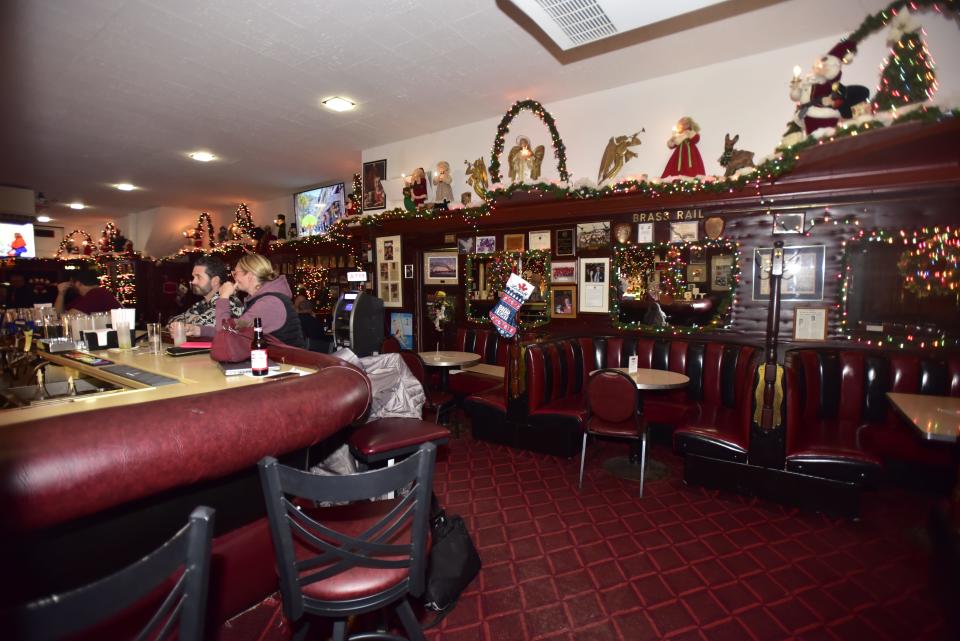 Patrons enjoy an afternoon drink at the Brass Rail Bar located on Huron Avenue in downtown Port Huron, on Wednesday, Dec. 7, 2022.