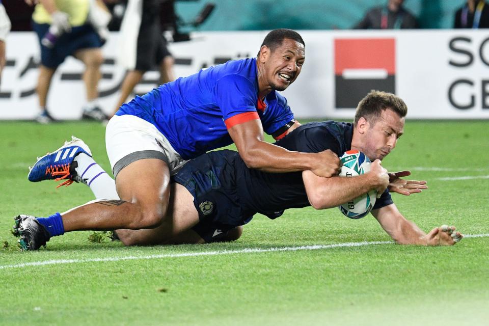 Scotland's scrum-half Greig Laidlaw (R) scores a try during the Japan 2019 Rugby World Cup Pool A match between Scotland and Samoa at the Kobe Misaki Stadium in Kobe on September 30, 2019. (Photo by Filippo MONTEFORTE / AFP)        (Photo credit should read FILIPPO MONTEFORTE/AFP/Getty Images)