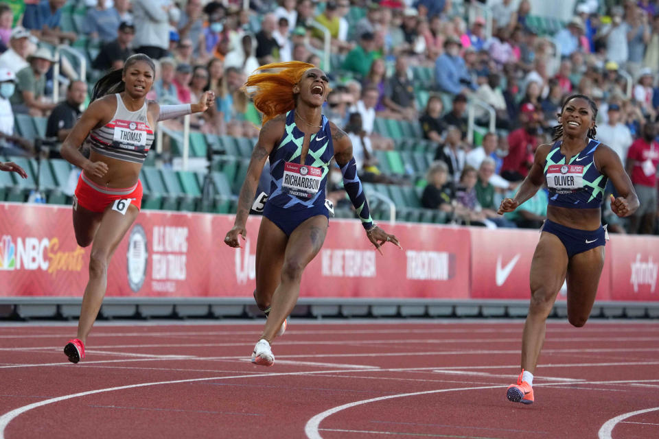 Sha'Carri Richardson (middle) celebrates after defeating Gabby Thomas (left) and Javianne Oliver to win the women's 100m in 10.86 during the US Olympic Team Trials at Hayward Field.