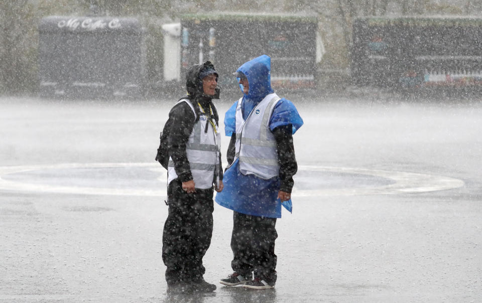 Stewards outside the stadium in heavy rain prior to the Premiership match at The AMEX Stadium, Brighton. (Photo by Gareth Fuller/PA Images via Getty Images)