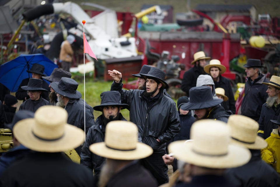 An auctioneer takes bids for farm equipment during the 56th annual mud sale to benefit the local fire department in Gordonville, Pa., Saturday, March 9, 2024. Mud sales are a relatively new tradition in the heart of Pennsylvania's Amish country, going back about 60 years and held in early spring as the ground begins to thaw but it's too early for much farm work. (AP Photo/Matt Rourke)