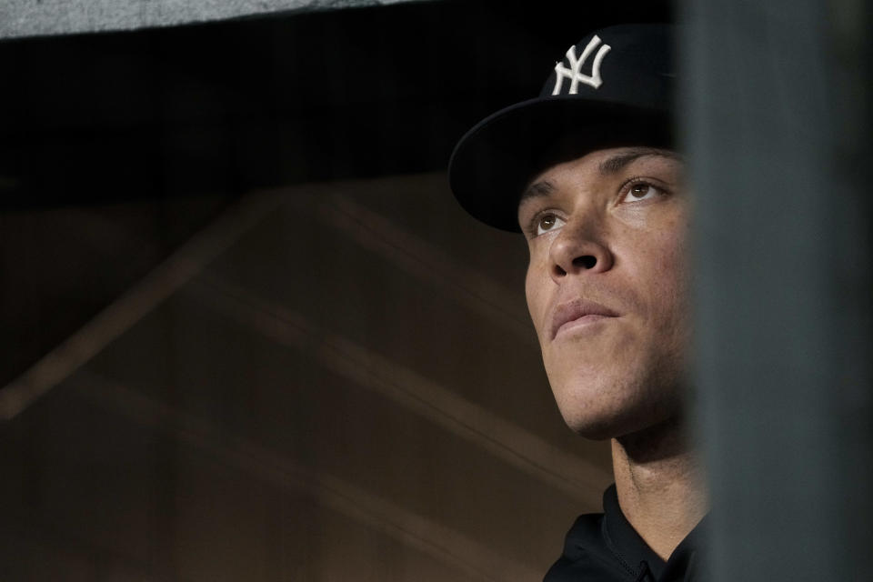 New York Yankees' Aaron Judge watches from the dugout during the eighth inning of the team's baseball game against the Texas Rangers on Friday, April 28, 2023, in Arlington, Texas. (AP Photo/Sam Hodde)