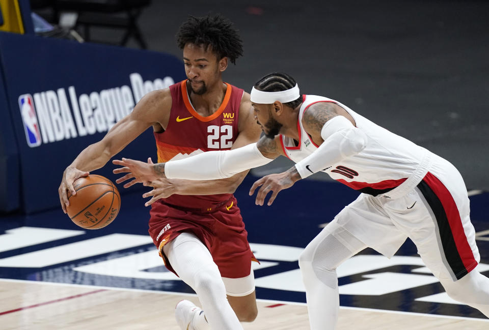 Denver Nuggets forward Zeke Nnaji, left, battles for control of a loose ball with Portland Trail Blazers forward Carmelo Anthony in the first half of an NBA basketball game on Tuesday, Feb. 23, 2021, in Denver. (AP Photo/David Zalubowski)
