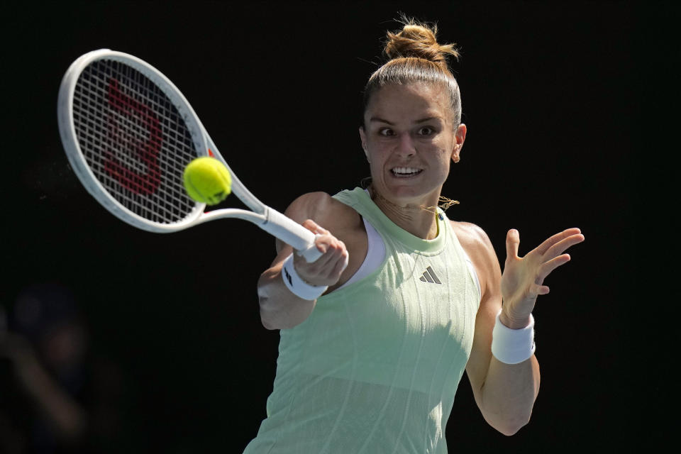 Maria Sakkari of Greece plays a forehand return to Nao Hibino of Japan during their first round match at the Australian Open tennis championships at Melbourne Park, Melbourne, Australia, Sunday, Jan. 14, 2024. (AP Photo/Andy Wong)