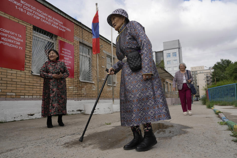 An elderly Mongolian woman arrives to vote at a polling station in Ulaanbaatar, Mongolia, Friday, June 28, 2024. (AP Photo/Ng Han Guan)