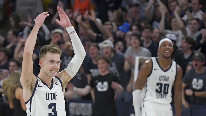 Utah State guard Steven Ashworth (3) and forward Dan Akin celebrate after defeating Boise State on Saturday, March 4, 2023, in Logan. The Aggies begin Mountain West tournament play on Thursday night.