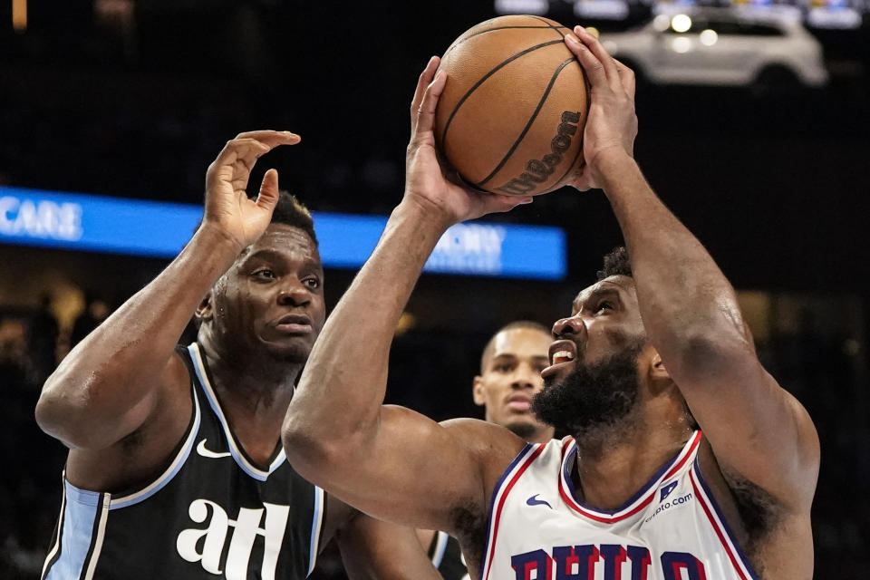 Philadelphia 76ers center Joel Embiid (21) shoots against Atlanta Hawks center Clint Capela (15) during the second half of an In-Season Tournament NBA basketball game, Friday, Nov. 17, 2023, in Atlanta. (AP Photo/Mike Stewart)