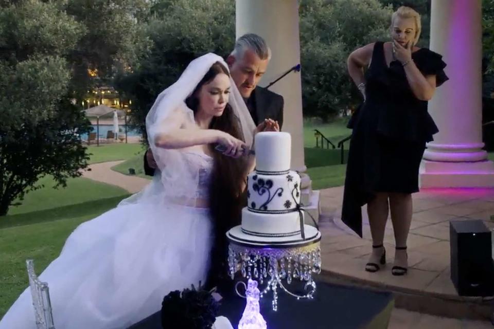 <p>TLC</p> Holly and Wayne cut their wedding cake on 90 Day Fiancé: The Other Way.