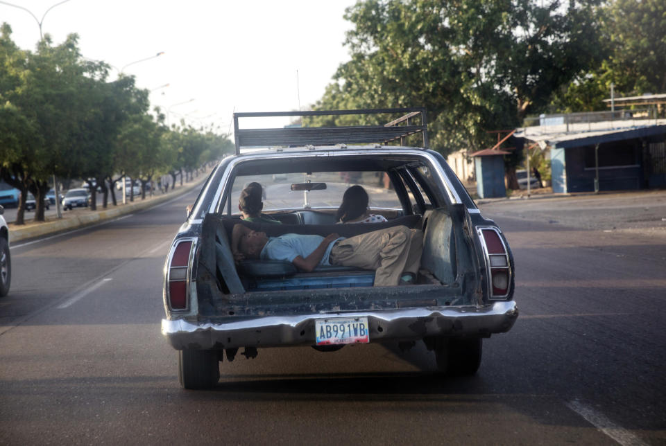 A man takes a nap in the back of a car in Maracaibo, Venezuela, May 15, 2019. Maracaibo's mood today is exhausted, due to the shortages of things that people need the most: cash, food, water, medicine, power, gasoline. (AP Photo/Rodrigo Abd)