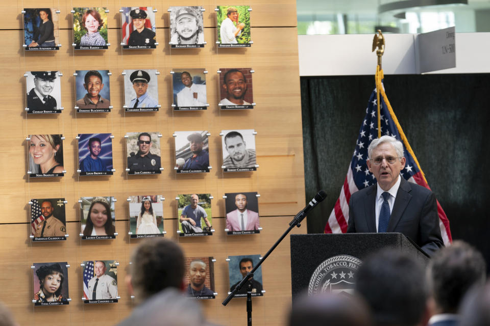 Attorney General Merrick Garland speaks next to a wall with photographs of victims of gun violence during the Inaugural Gun Violence Survivors' Summit at ATF Headquarters in Washington, Tuesday, April 23, 2024. (AP Photo/Jose Luis Magana)