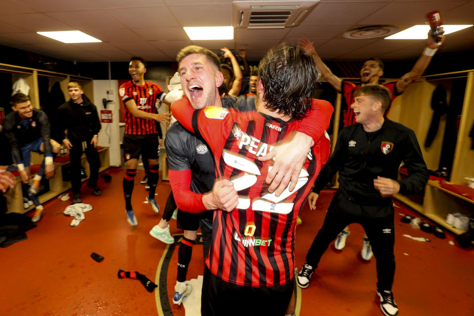 Chris Mepham (pictued left) and Ben Pearson (pictured right) of Bournemouth celebrate after their sides 1-0 win gained them automatic promotion to the Premier League.