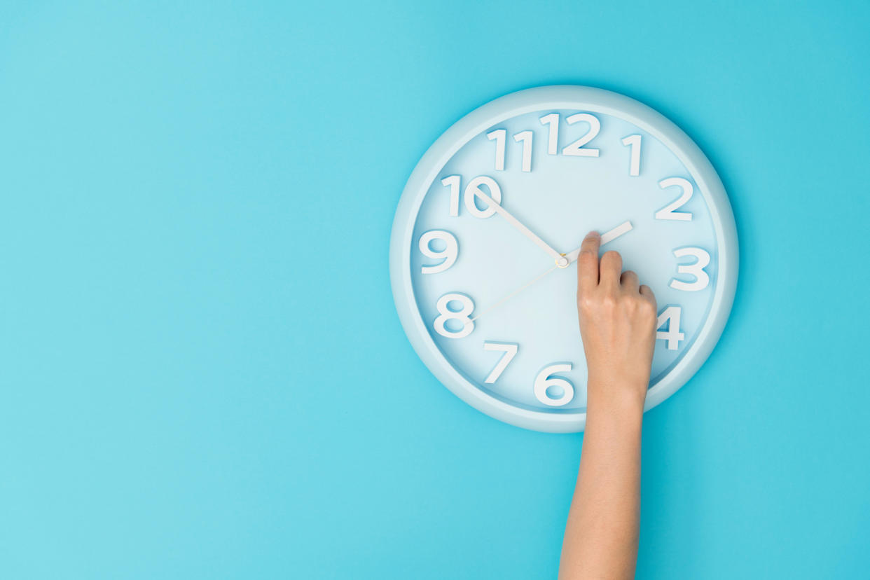 clock on blue background illustrating daylight saving time