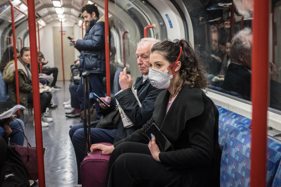 A woman seen on a tube wearing a face mask. A total of nine people in the UK are now being treated for COVID-19, the disease caused by the coronavirus. Doctors have warned that the London Underground could be a hotbed for the coronavirus. (Photo by S.C. Leung / SOPA Images/Sipa USA)